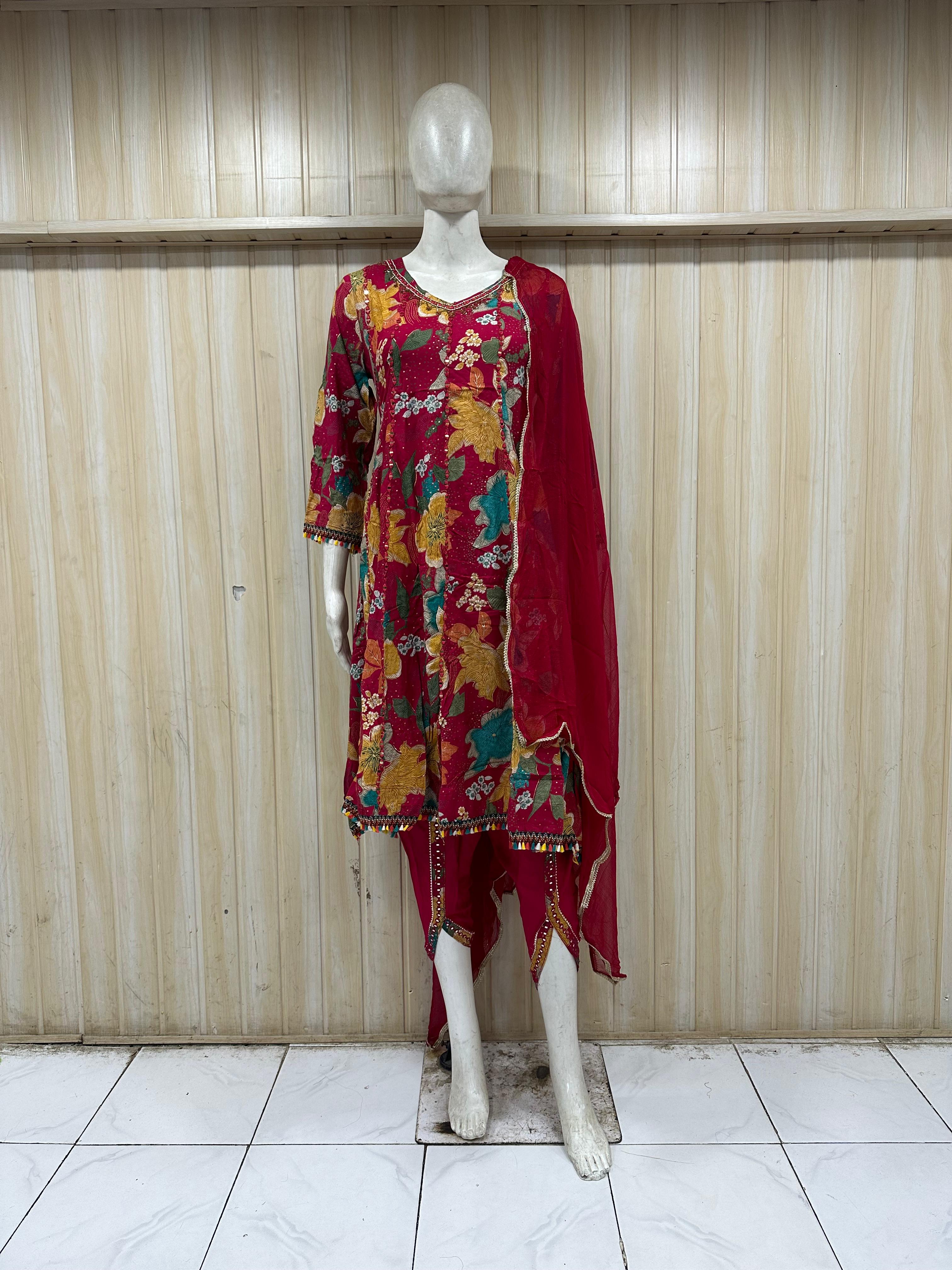 This is a stylish red floral printed kurti set displayed on a mannequin, featuring:  Bold multicolor floral print (yellow, green, beige tones) 🌸