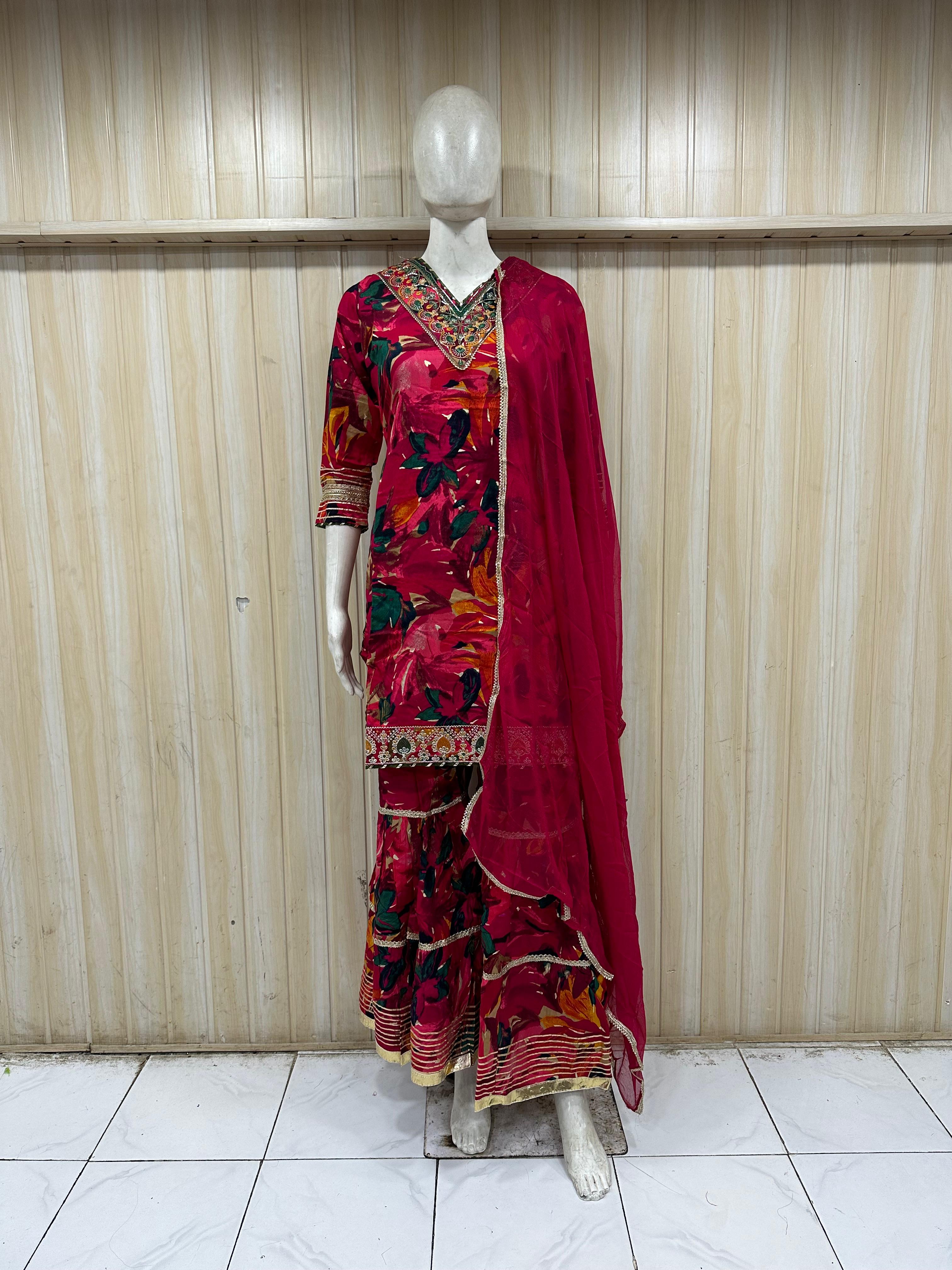 This is a vibrant red floral printed kurti set displayed on a mannequin, featurin