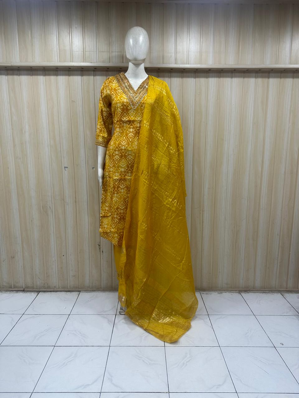 This is a professional fashion photoshoot–style image of a model wearing a mustard yellow traditional kurti set with dupatta. It looks premium and suitable for online catalog, Instagram ads, or boutique promotion.