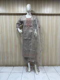 mannequin waering a traditional embroidered designs outfit with asheer dupatta against a striped wall