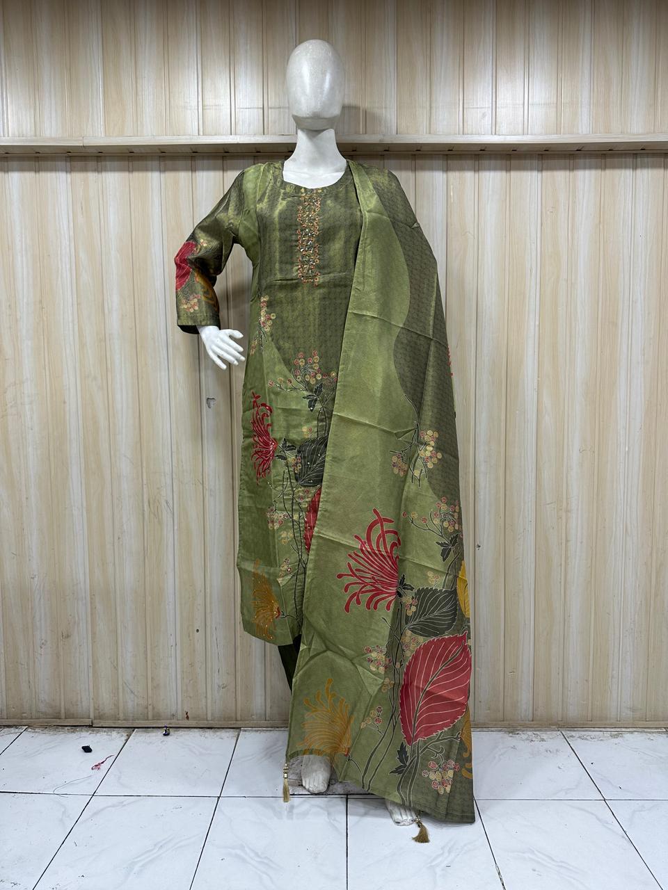 mannequin waering a green floral drees against a striped wall