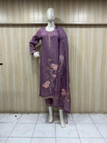 purple embroidered outfit on a mannequin against a striped wall