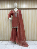 red treditional outfith a intricat embroidered  a mannequin against a striped wall