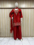 red embroidered treditional on a mannequin against a striped wall