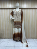 mannequin weaering a long, patterned dres with gradient effect against a striped wall