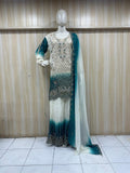 mannequin weaering a traditional outfit with a gradient desing  against a wooden panel striped backgrauond