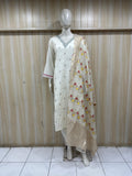 mannequin waering a white kurta traditional with floral dupatta against a wooden panel