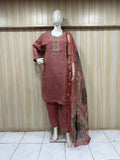 maroon traditional outfit with embroiered detials on a mannequin against a striped wall