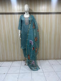 teal embroiered traditional on a annequin against a striped wall