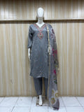 mannequin wearing a traditional gray kurta with a floral dupatta against a striped wall