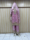 mannequin wearing pink traditional dress outfit against a striped wall