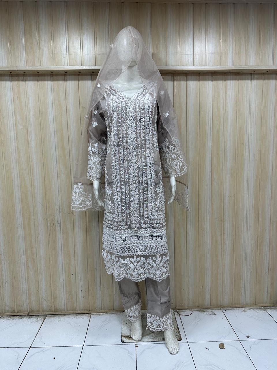 mannequin wearing traditional outfit with a intricate patterns against a striped wall