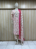 mannequin wearing a white and red floral outfit with a matching dupatta shawl headscraf against a striped wall