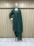 mannequin wearing a dark green embroidered floral outfit with a matching dupatta dupatta against a striped wall