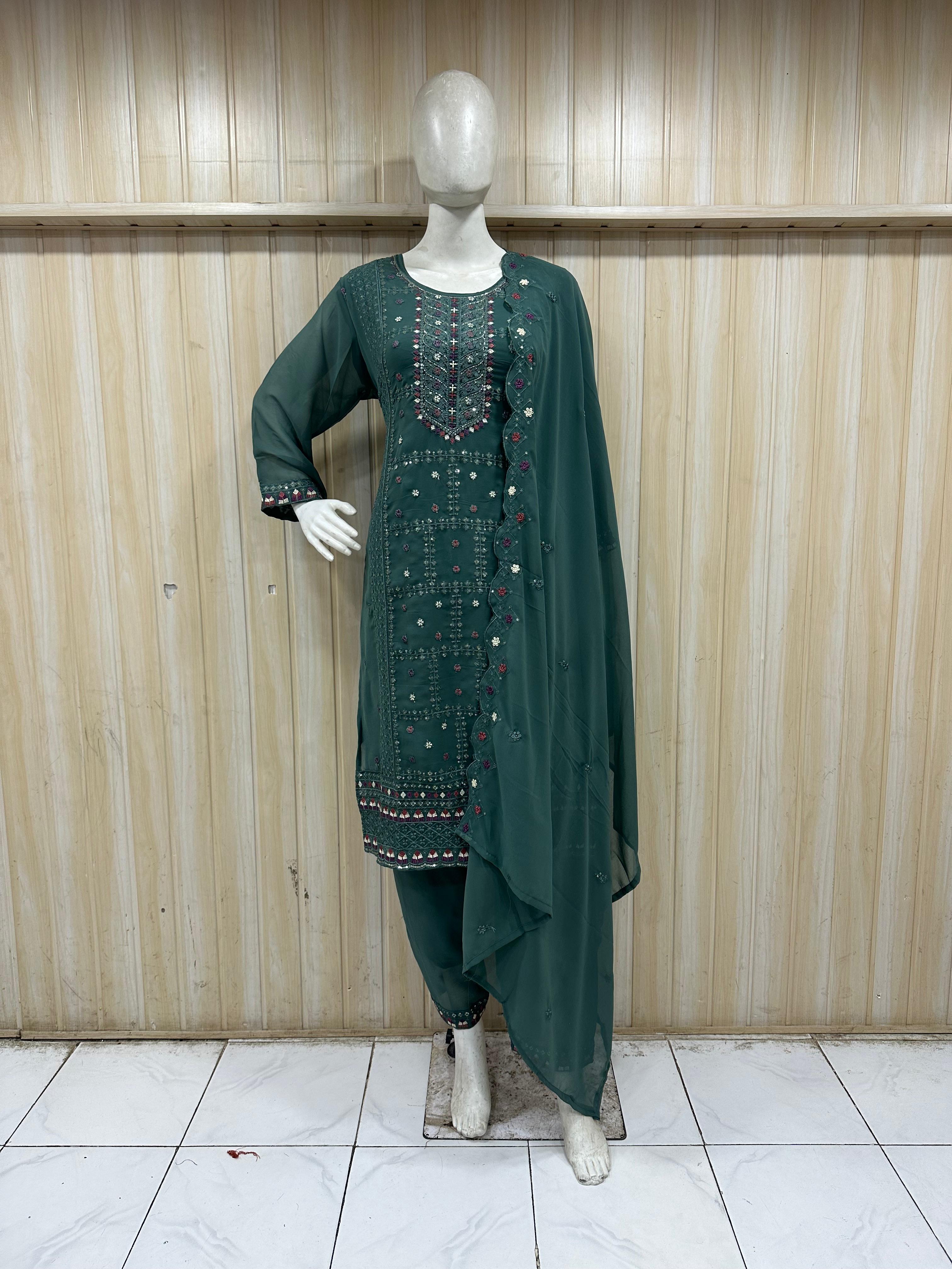 mannequin wearing a dark green embroidered floral outfit with a matching dupatta dupatta against a striped wall