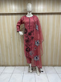 mannequin wearing a pink and black traditional floral outfit with a matching dupatta shawl headscraf against a wooden panel