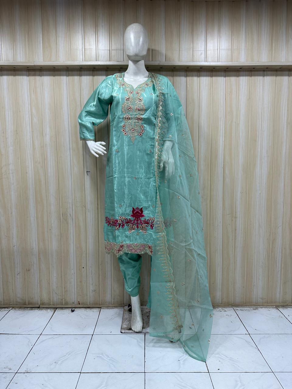 mannequin wearing a light blue embroidered outfit with asheer dupatta Floral Traditional against astriped wall