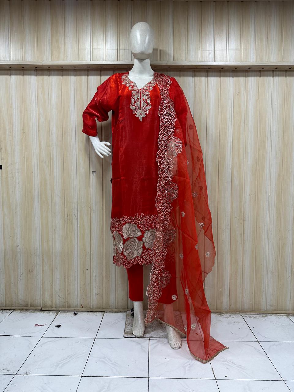 mannequin wearing a red embroidered outfit with dupatta Floral Traditional against astriped wall