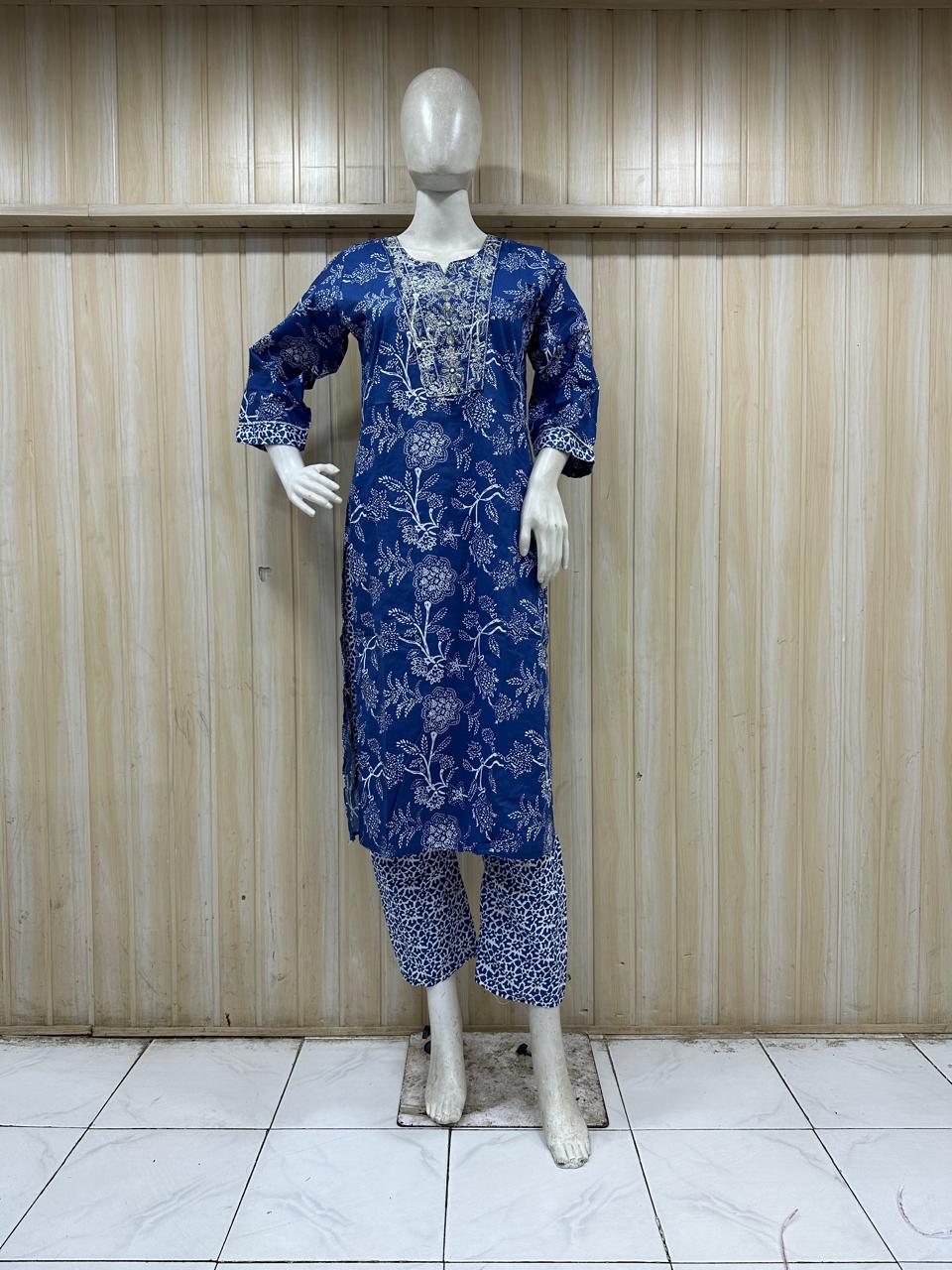 mannequin wearing a blue outfit with Floral Traditional against a wooden panel background