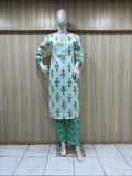 mannequin wearing a white and green outfit with dress Floral dress Traditional against a wooden panel background