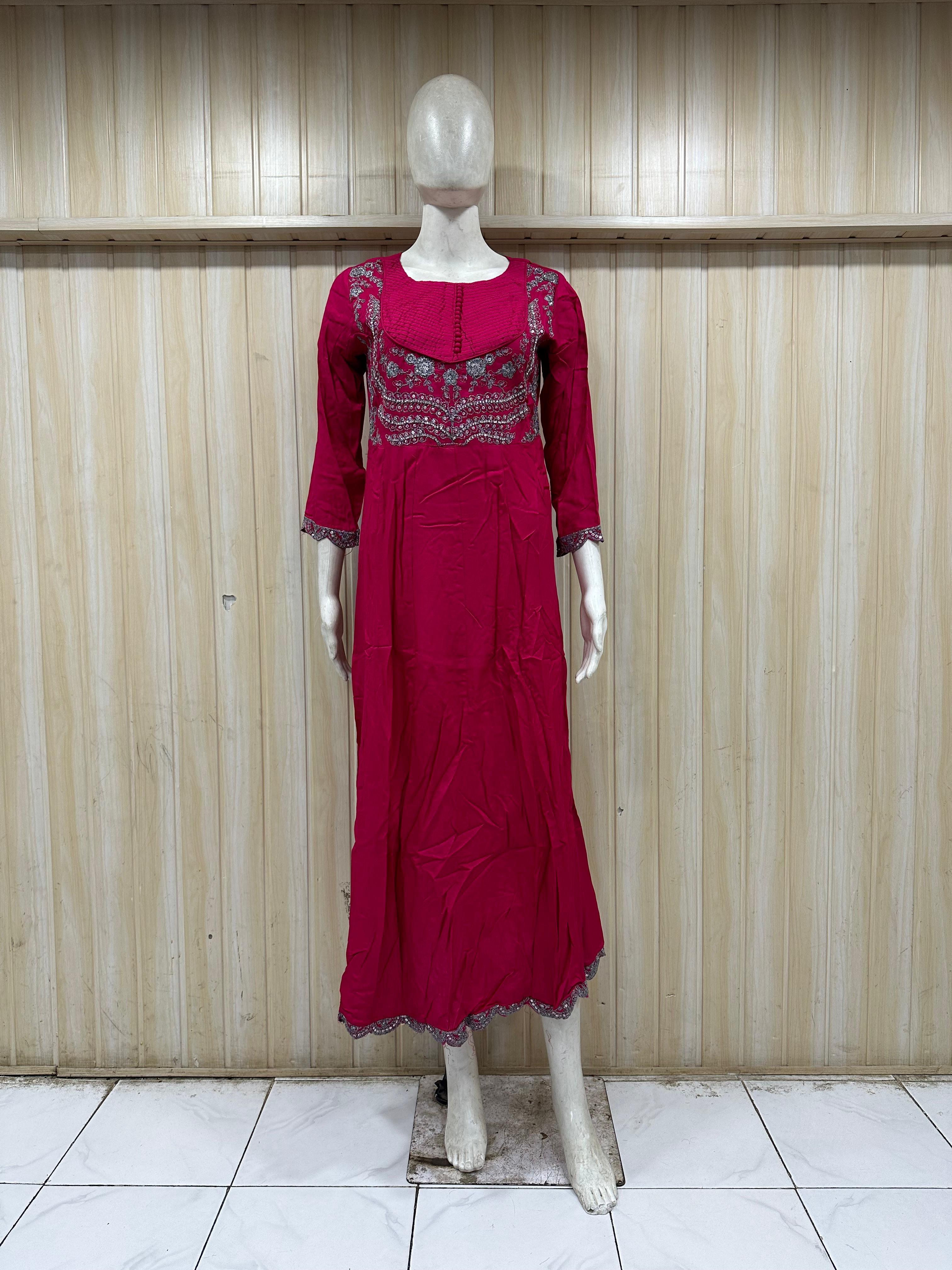mannequin wearing a red outfit with dress Floral intricate detailing Traditional against a striped wall