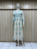 mannequin wearing a light outfit with dress Floral intricate detailing Traditional against a striped wall