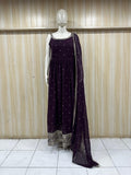mannequin wearing a dark purpal outfit with dress silver embellishments Floral Traditional against a striped wall