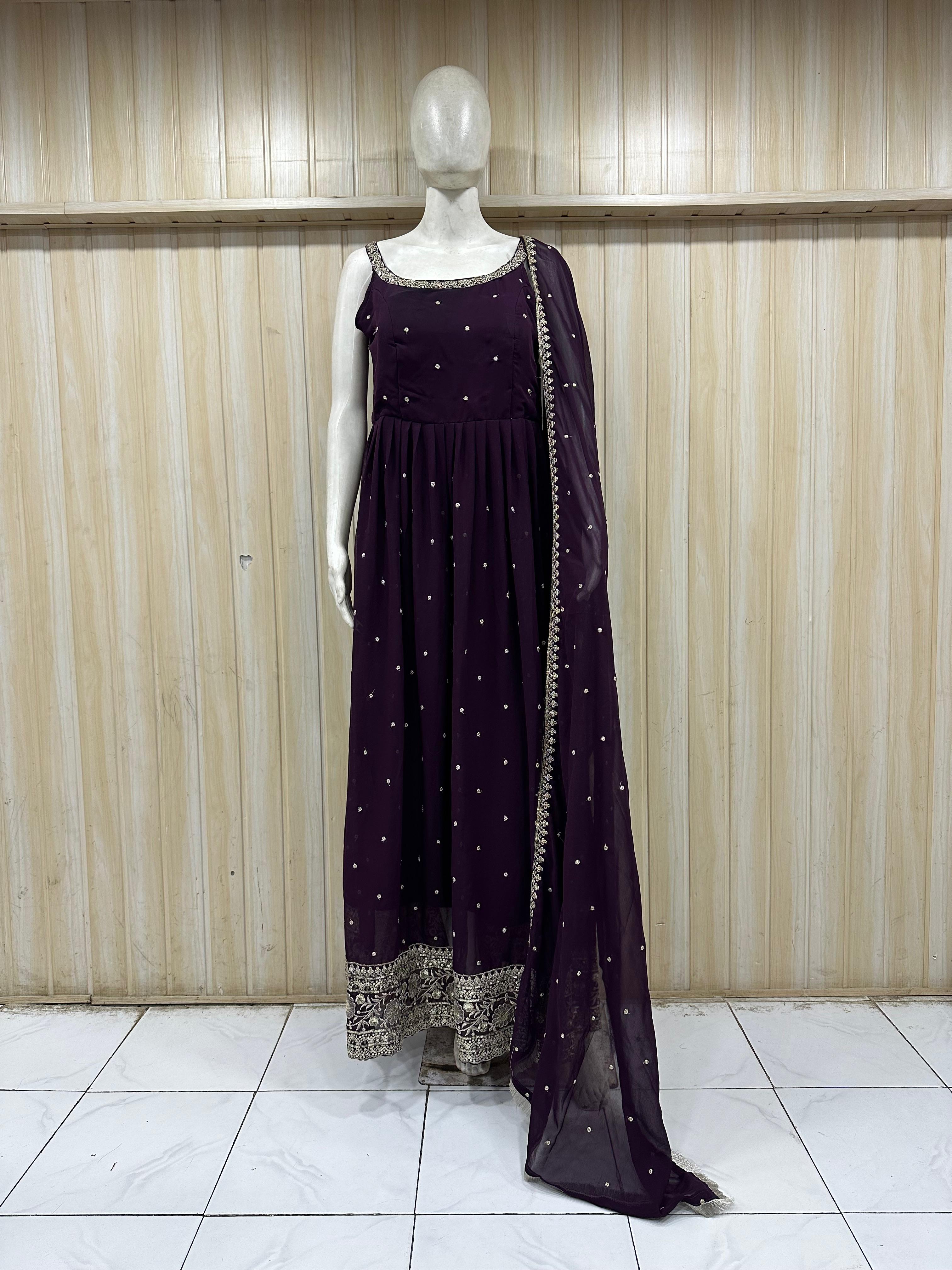 mannequin wearing a dark purpal outfit with dress silver embellishments Floral Traditional against a striped wall