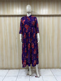 mannequin wearing a purpal dress outfit with colorful dupatta Floral Traditional against a striped wall