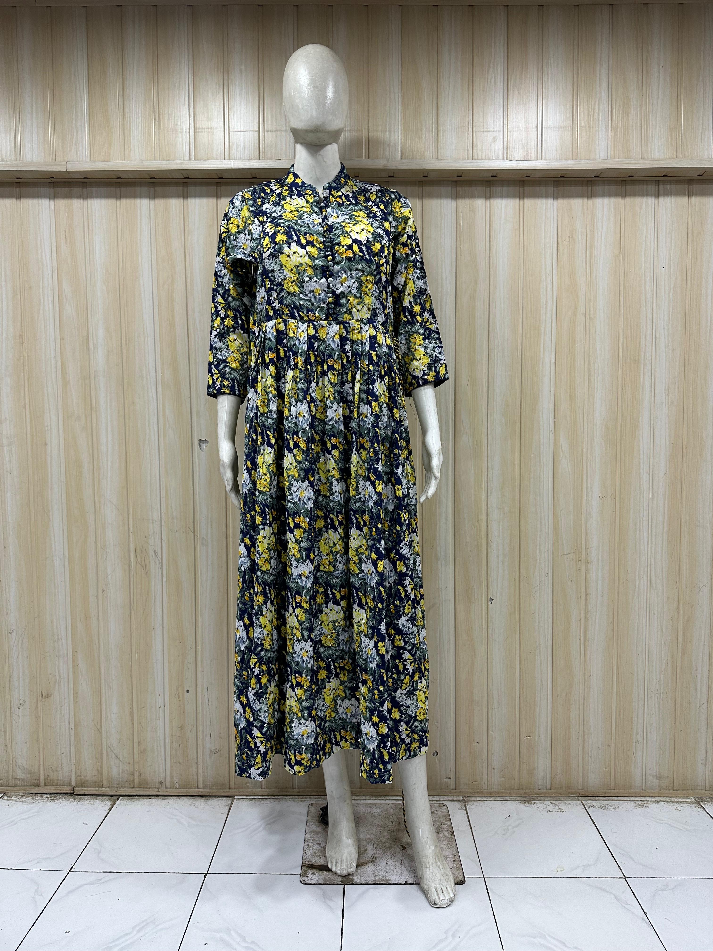 mannequin wearing a floral dress outfit with colorful dupatta Traditional against a wooden panel background