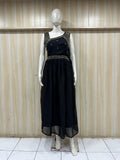mannequin wearing a black floral dress outfit with  Traditional against a wooden panel background
