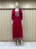 mannequin wearing a dark pink floral dress outfit with Traditional against a wooden panel background