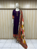mannequin wearing a dark purpal floral dress outfit with colorful dupatta Traditional against a wooden panel background
