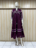 mannequin wearing a purpal floral dress outfit with  Traditional against a wooden panel background