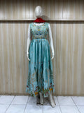 mannequin wearing a sky blue and red embroidered floral dress outfit with Traditional against a wooden panel background