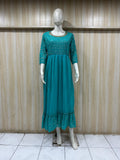 mannequin wearing a sky blue floral dress outfit with Traditional against a wooden panel background
