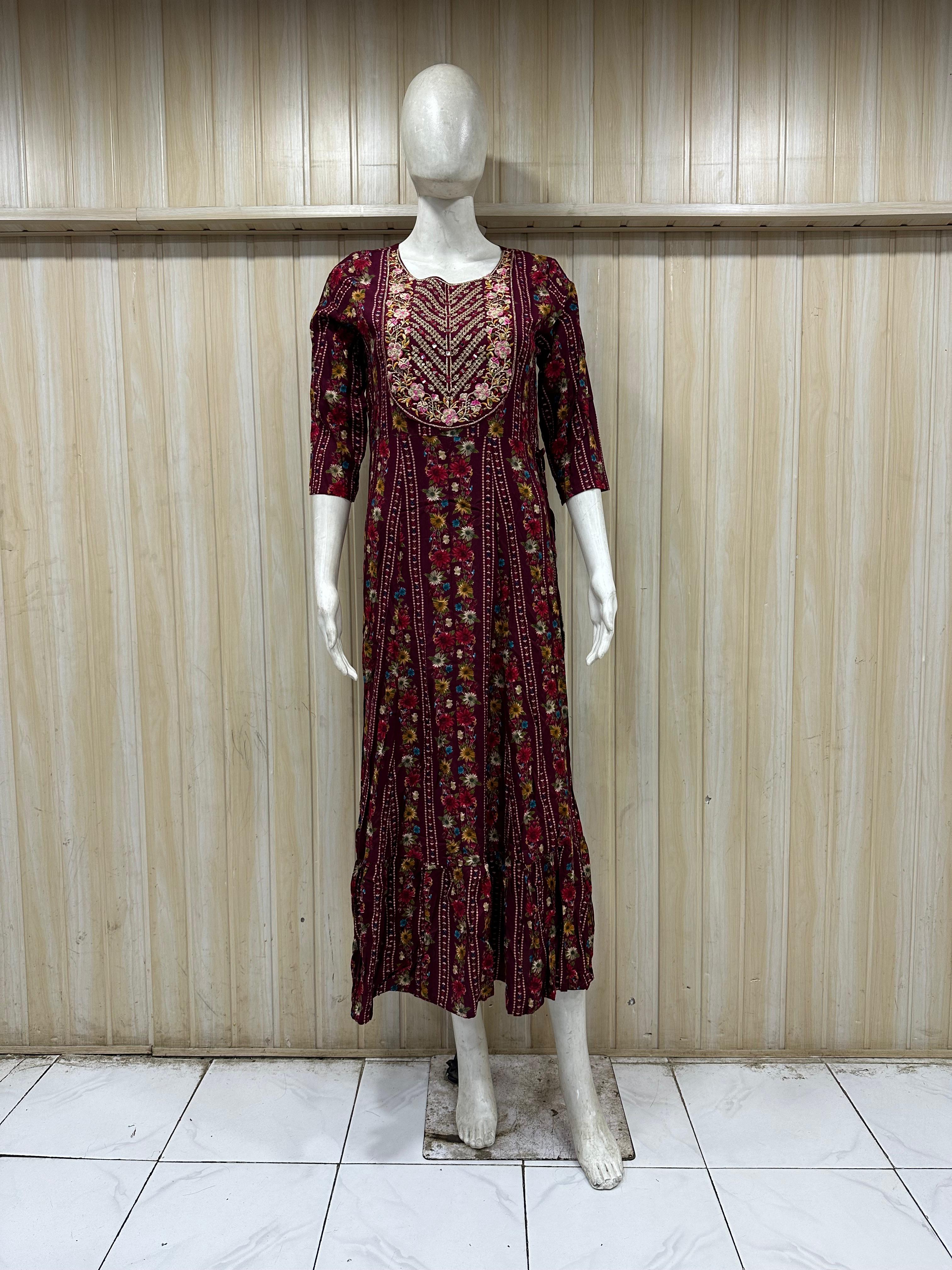 mannequin wearing a maroon floral dress outfit with Traditional against a wooden panel background