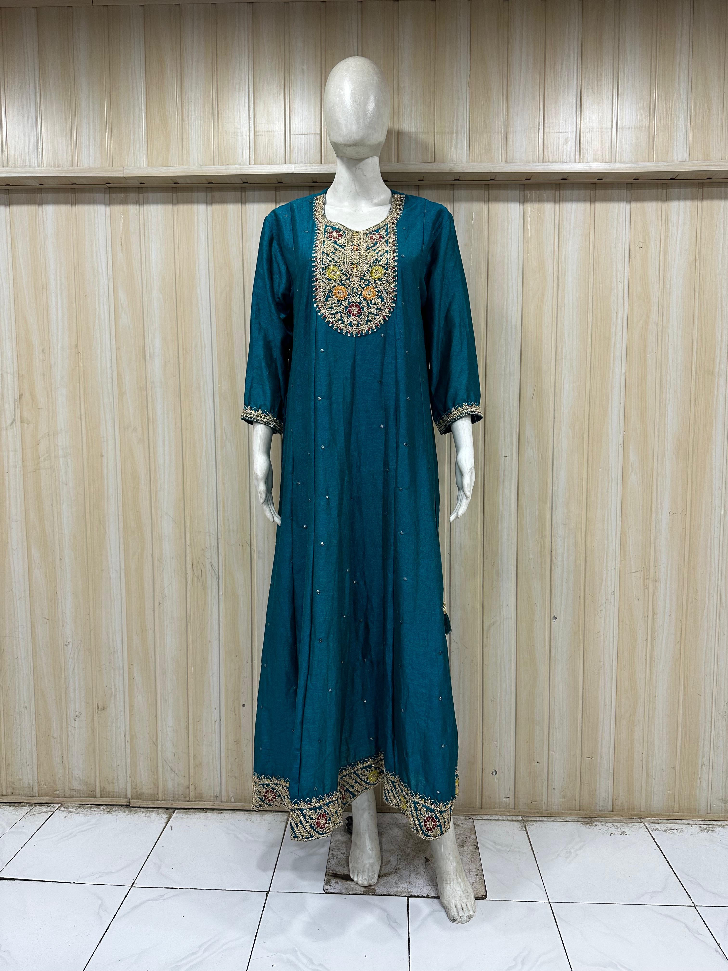 mannequin wearing a teal floral dress outfit with Traditional against a wooden panel background
