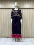 mannequin wearing anyve blue floral dress outfit with Traditional against a wooden panel background  ChatGPT6:45 PM