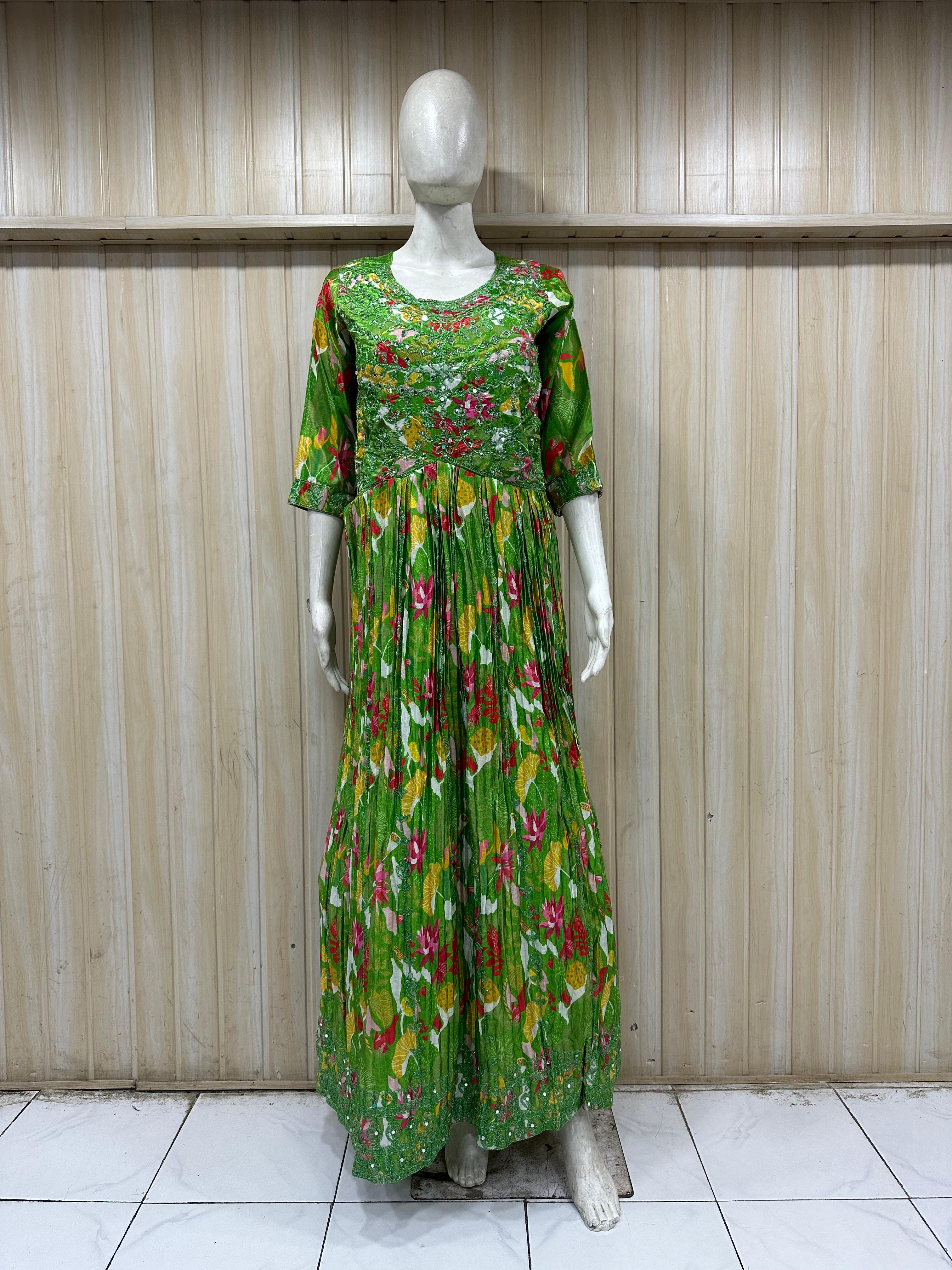 mannequin wearing a green floral dress outfit with Traditional against a wooden panel background
