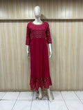 mannequin wearing a  dark black floral dress outfit with Traditional against a wooden panel background