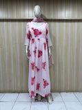 mannequin wearing a white and pink floral dress outfit with Traditional against a wooden panel background