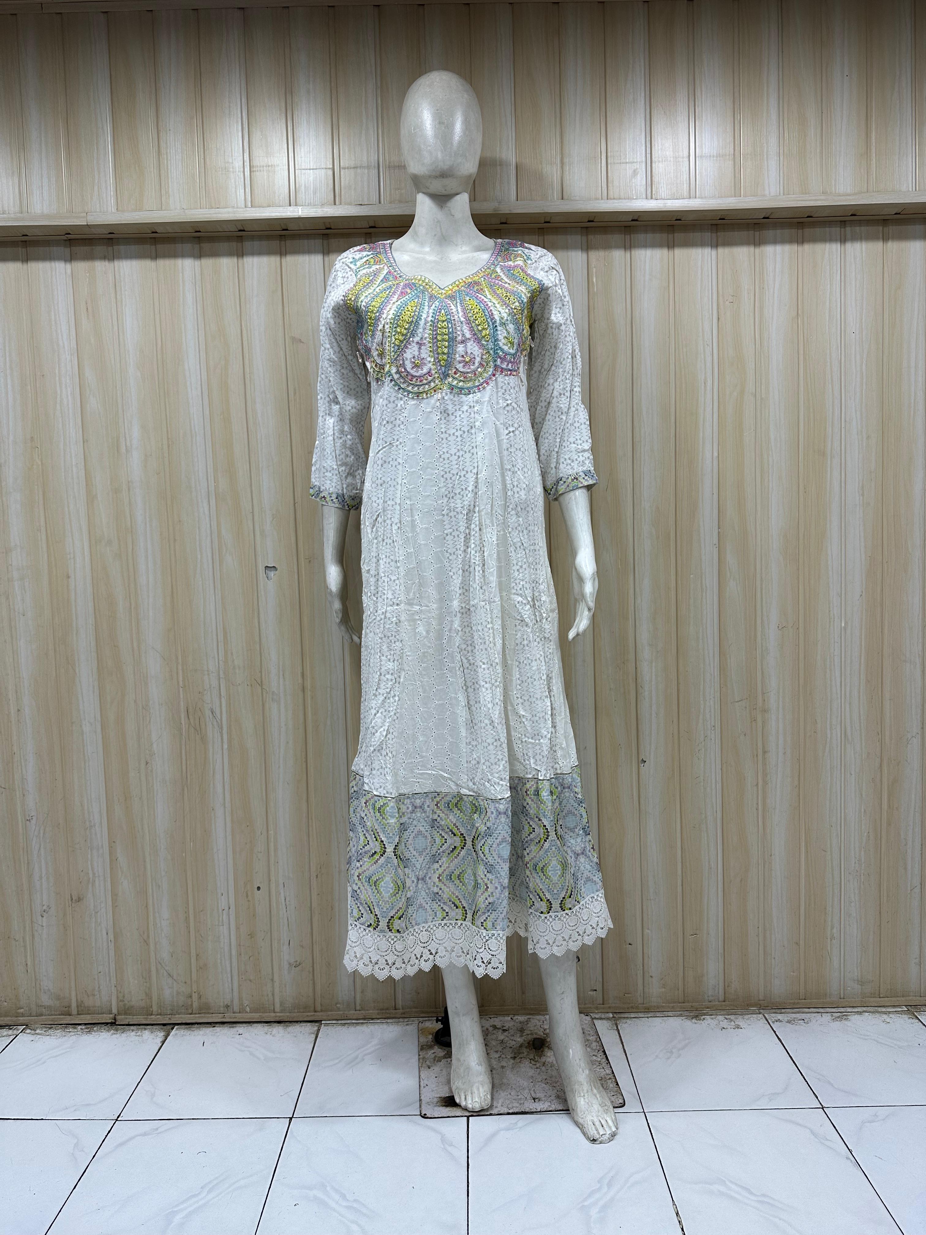 mannequin wearing a white floral dress emboridered outfit with Traditional against a wooden panel background