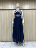 Navy blue dress with floral embellishments on a mannequin against a wooden panel background