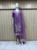 Purple traditional outfit with white embroidery on a mannequin against a striped