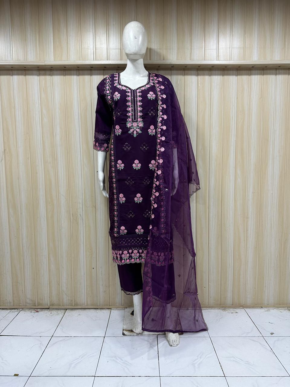 purpal kurta with pink and gold embroidery paired with a red and gold dupatta on a mannequin against a striped