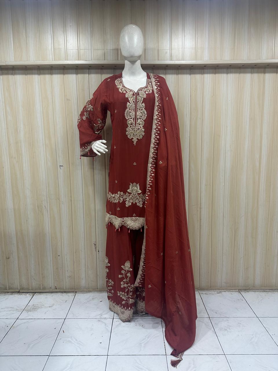 mannequin wearing a brouwn embroidered outfit against a striped