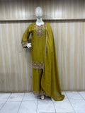 Green embroidered traditional outfit on a mannequin against a striped