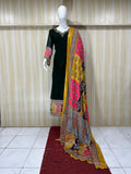 Mannequin wearing a black dress with colorful patterns and a matching dupatta against a striped