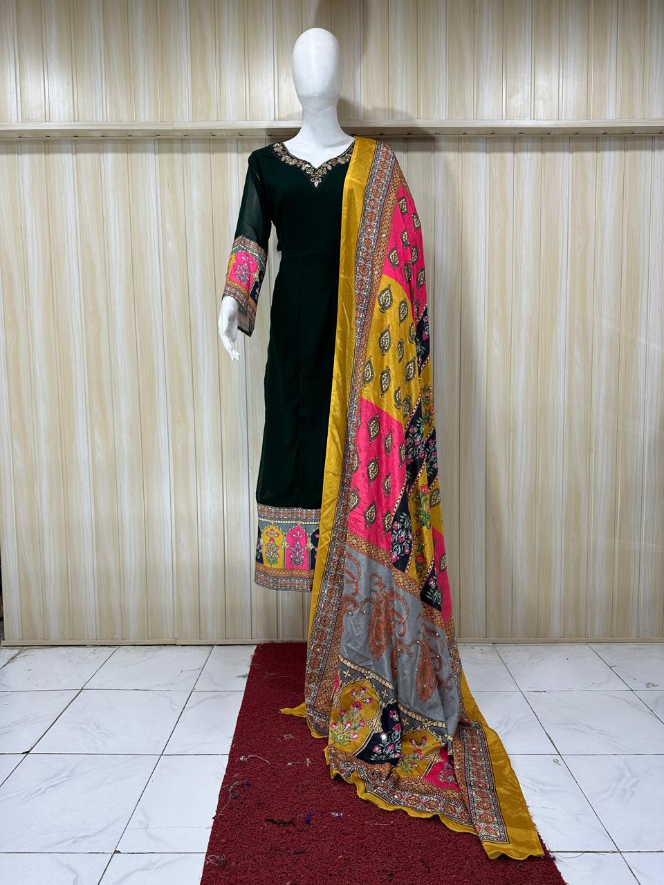 Mannequin wearing a black dress with colorful patterns and a matching dupatta against a striped